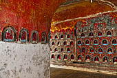 Myanmar, Burma, Nyaungshwe. Small Buddhas set into the temple wall, Shwe Yaunghwe Kyaung monastery, near Inle Lake. 